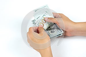 Hands counting one hundred US dollar money bills on white background in concept of money exchange, business and financial.